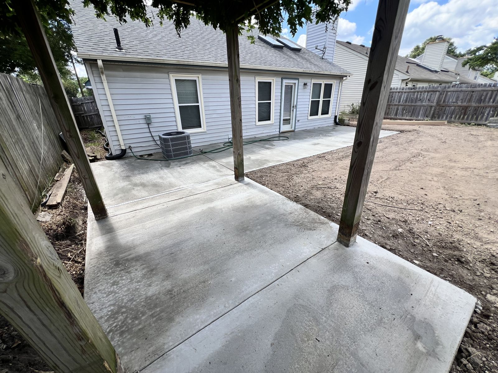 Completed backyard concrete patio and walkway connection