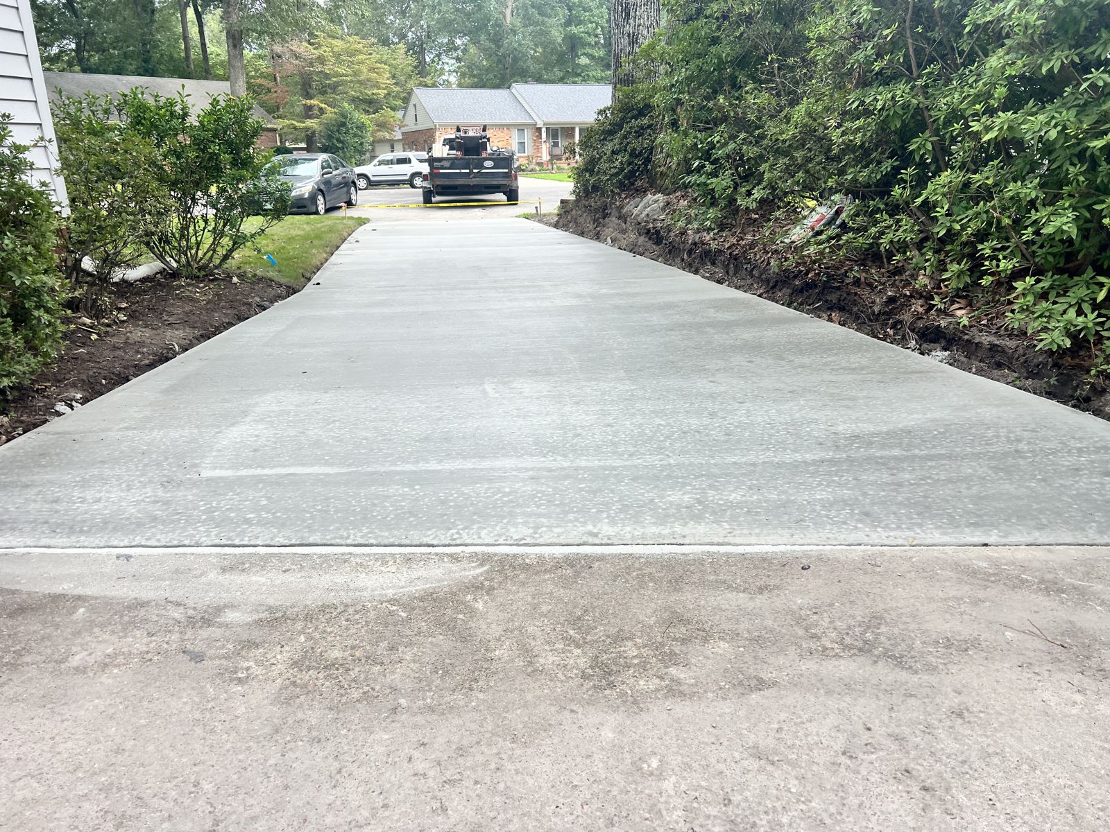 Long concrete driveway freshly poured to the street