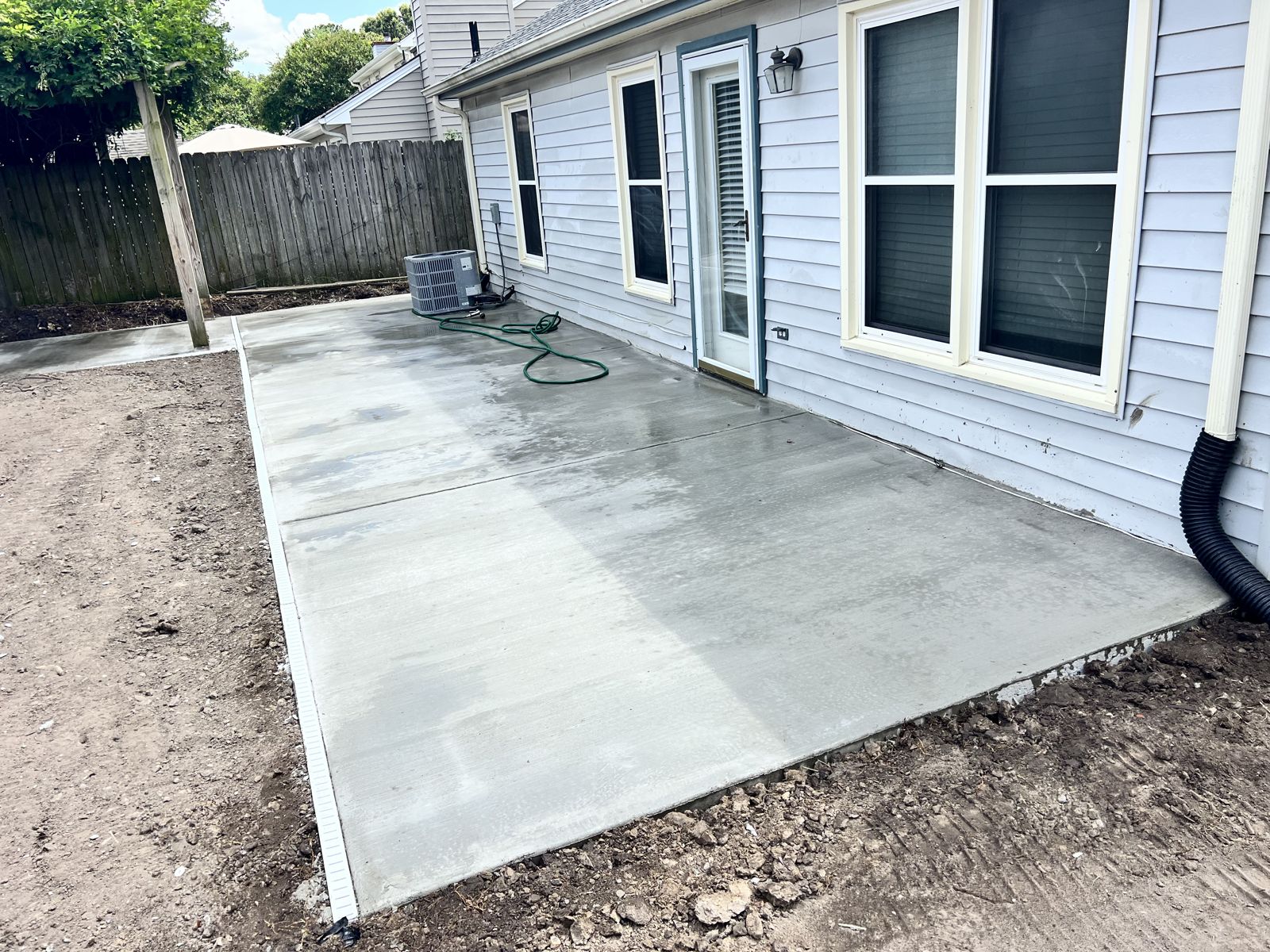 Broom-finish concrete patio along the back of a Virginia Beach home