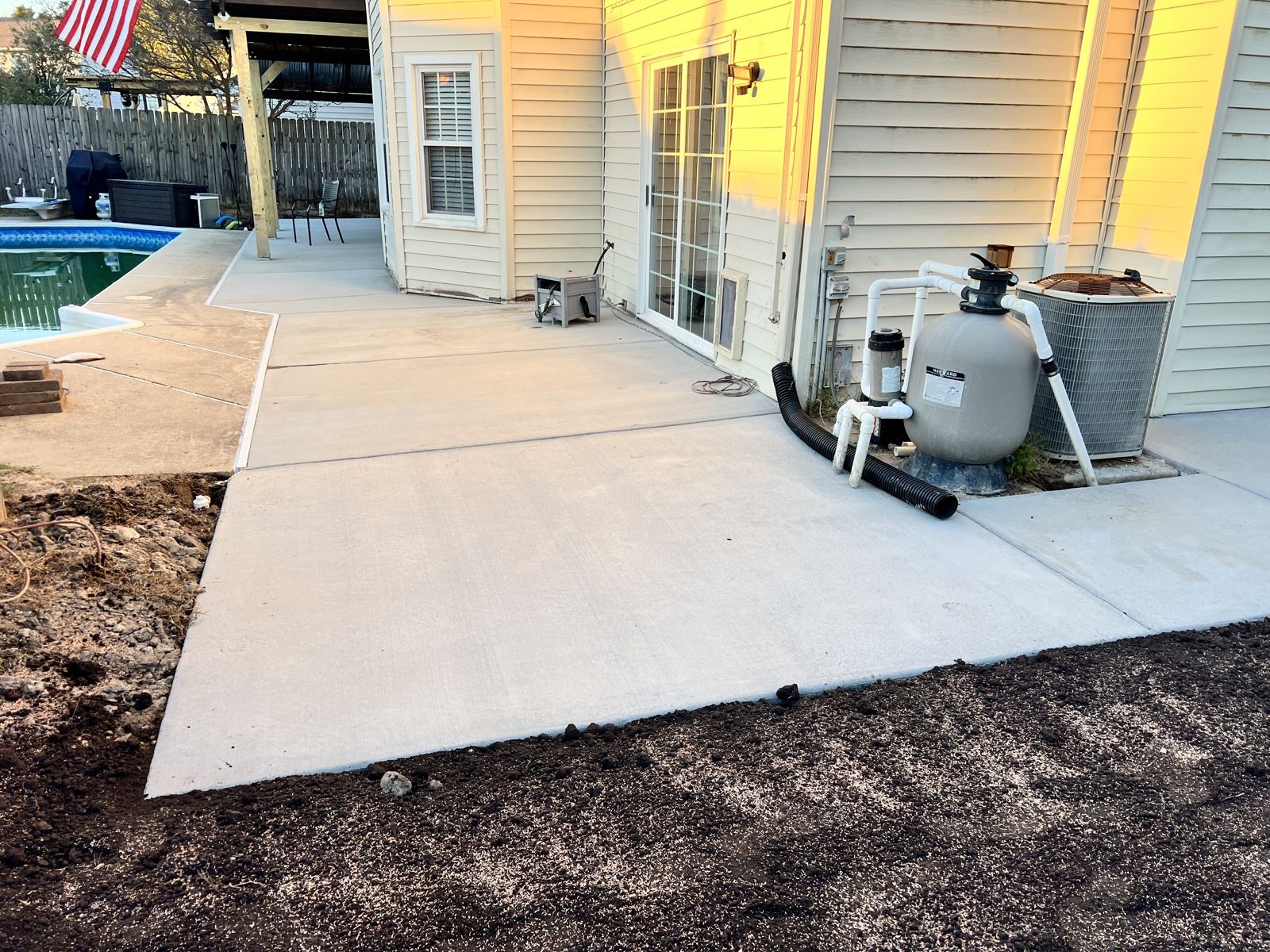 Concrete pool deck extension tied into existing patio